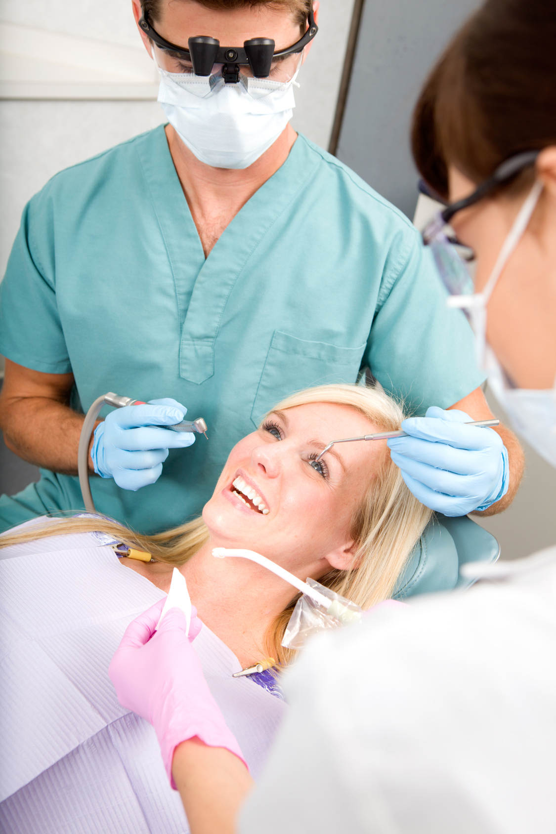 A woman at the dentist about to have some drilling done